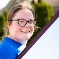 An Alumna carrying a mirror.
